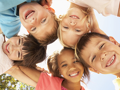 A group of children smiling at the camera.